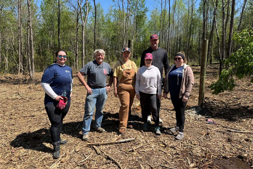 Helping Hands volunteers from Intrepid, an SPA Company, rolled up their sleeves and got to work at Next Step Farms.